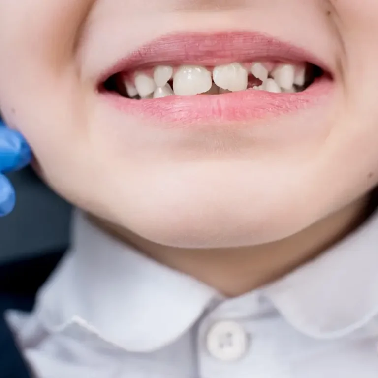 Female dentist examines the teeth of the patient child